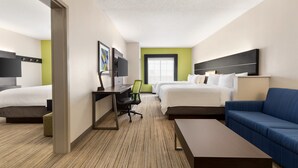 A hotel room with two beds, a desk, a chair, a sofa, and a television. - Holiday Inn Express & Suites Shawnee by IHG (Shawnee)