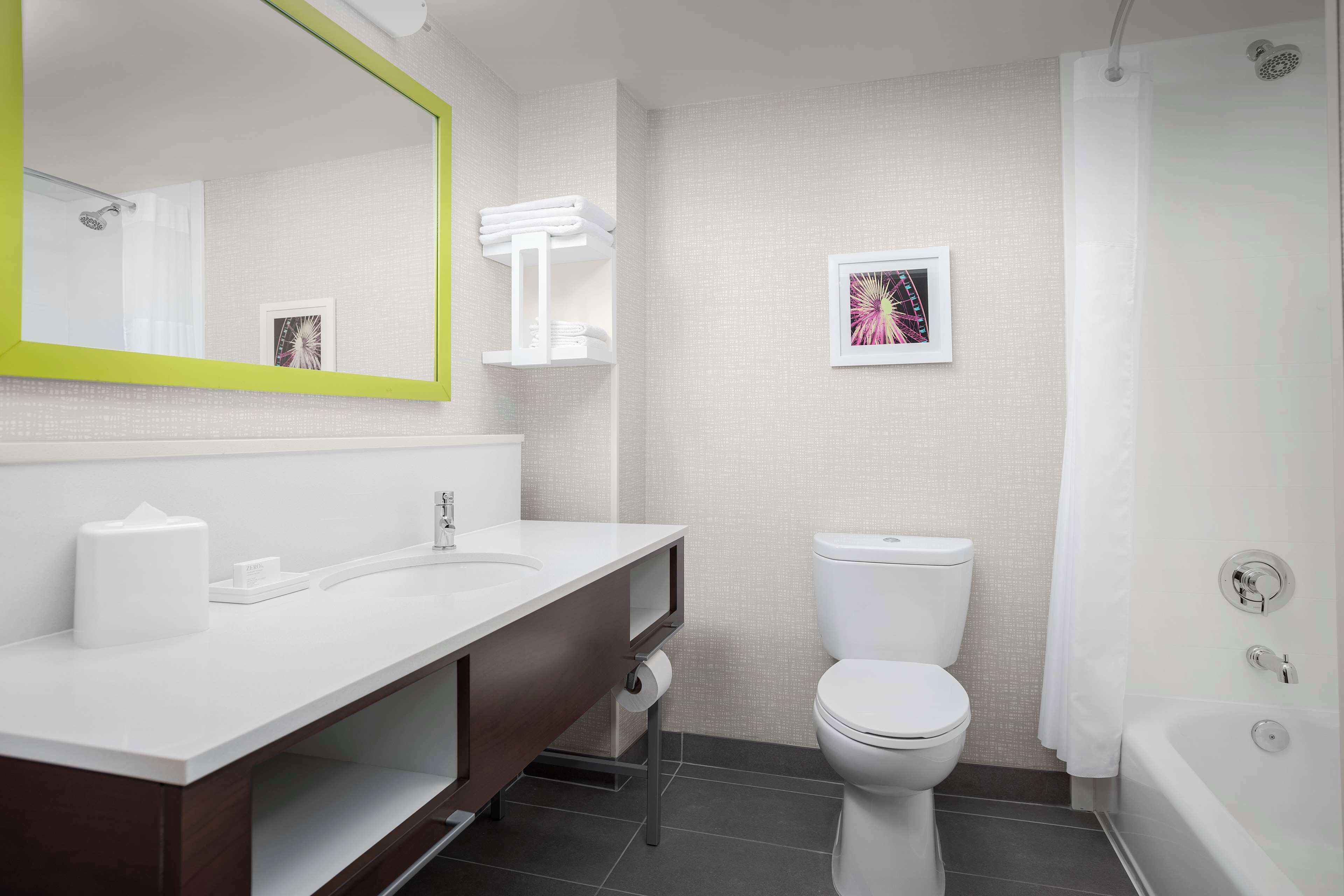 A modern bathroom with a white sink, a toilet, and a bathtub.
