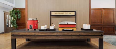 A breakfast bar with a sign that reads "HAPPY BREAKFAST STARTS HERE".