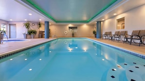A swimming pool with a tiled deck, lounge chairs, and potted plants. - Hampton Inn & Suites Wells-Ogunquit (Wells)