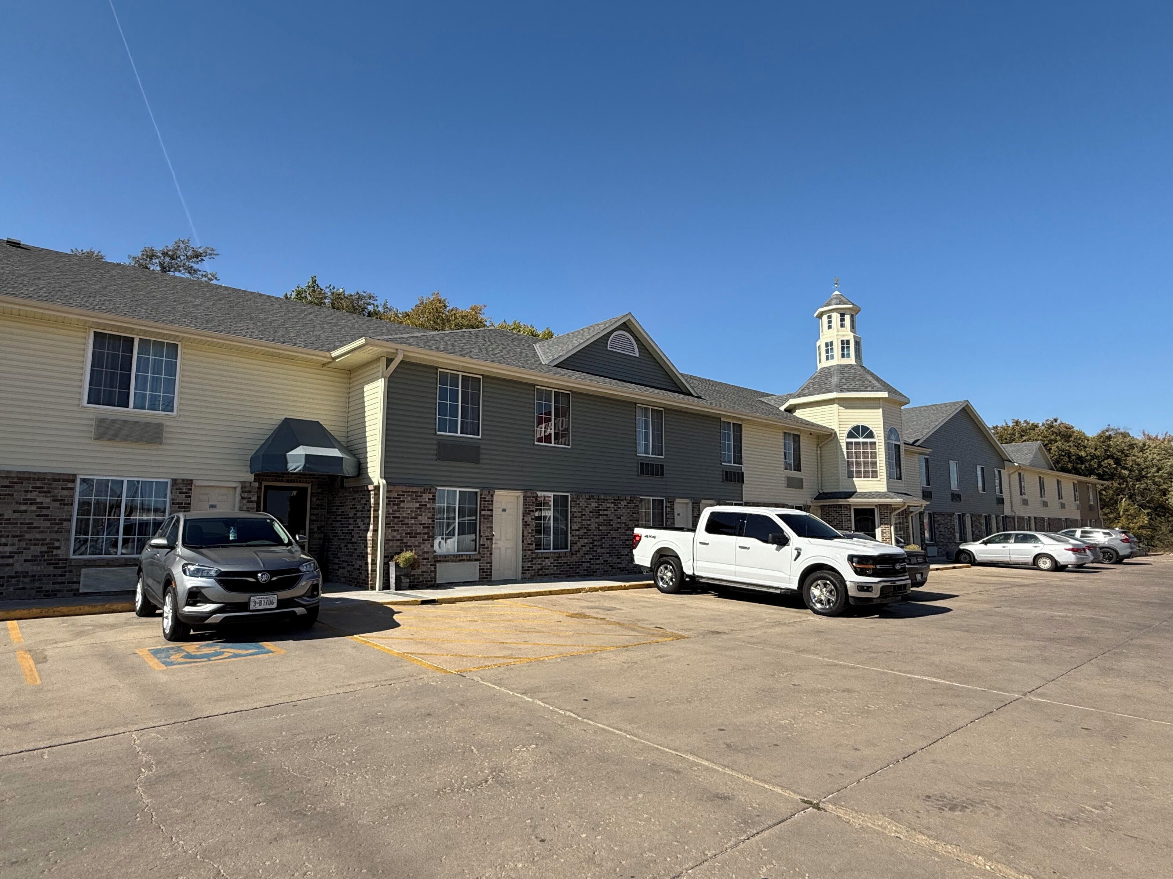 A multi-story building with a parking lot.