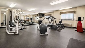 A gym with various exercise equipment, including treadmills, elliptical machines, and weight machines. - Baymont by Wyndham Rawlins (Rawlins)