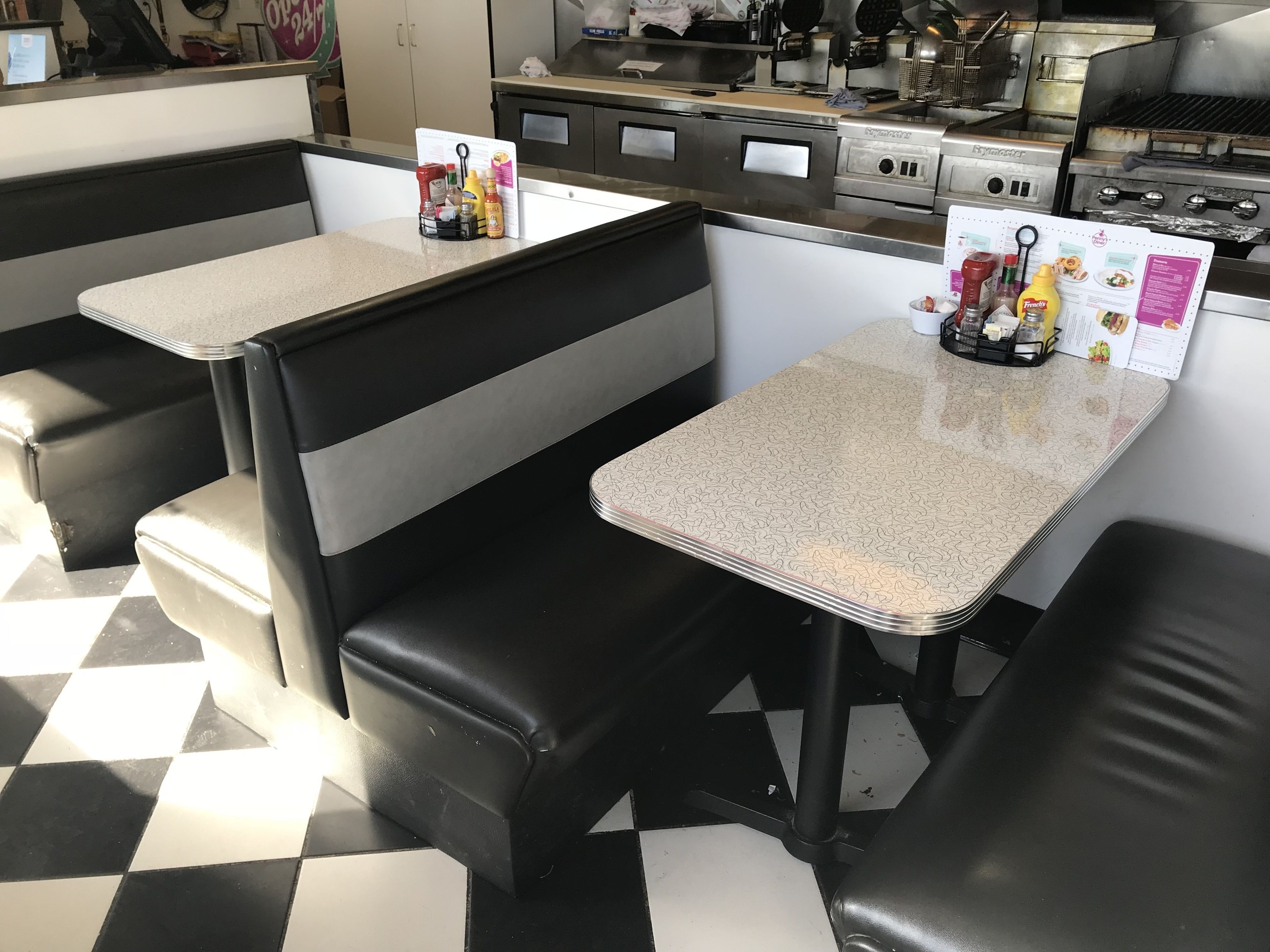 A diner with booth seating and a menu board.