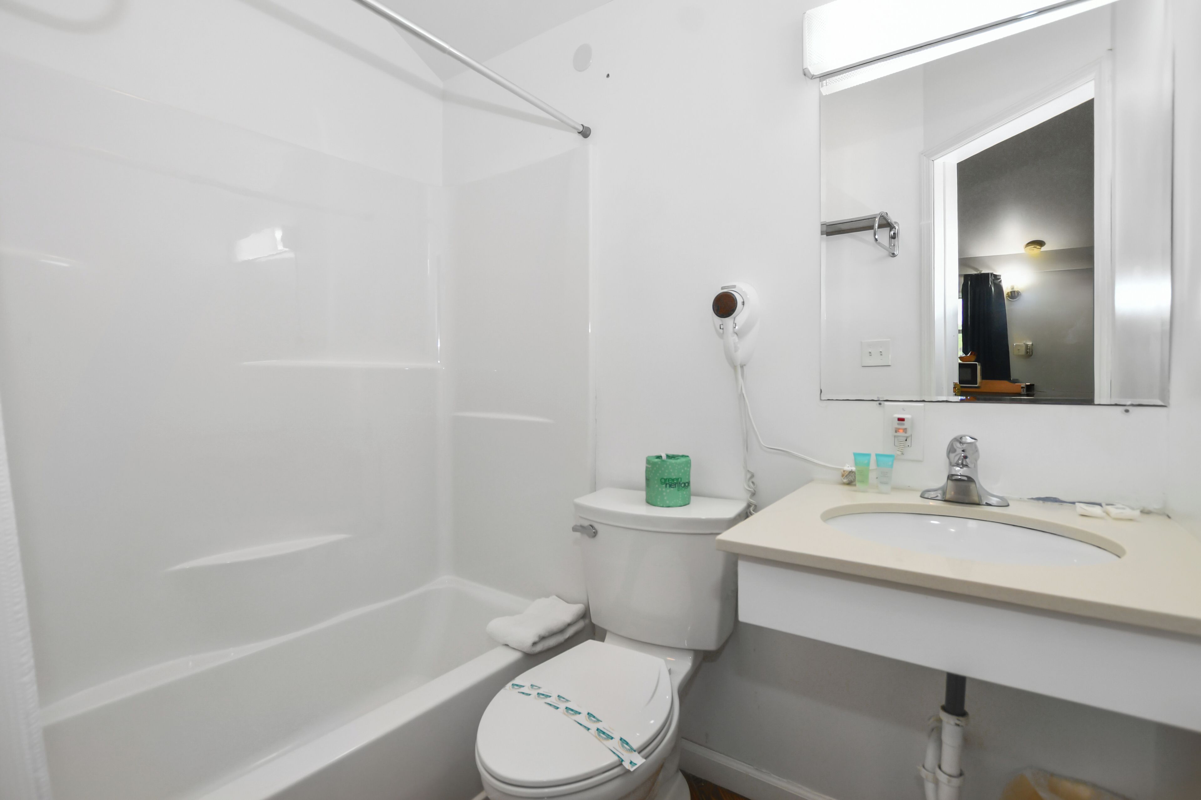 A bathroom with a bathtub, toilet, and sink.