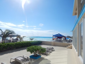 Relax by the ocean with comfortable lounge chairs and a serene atmosphere.
