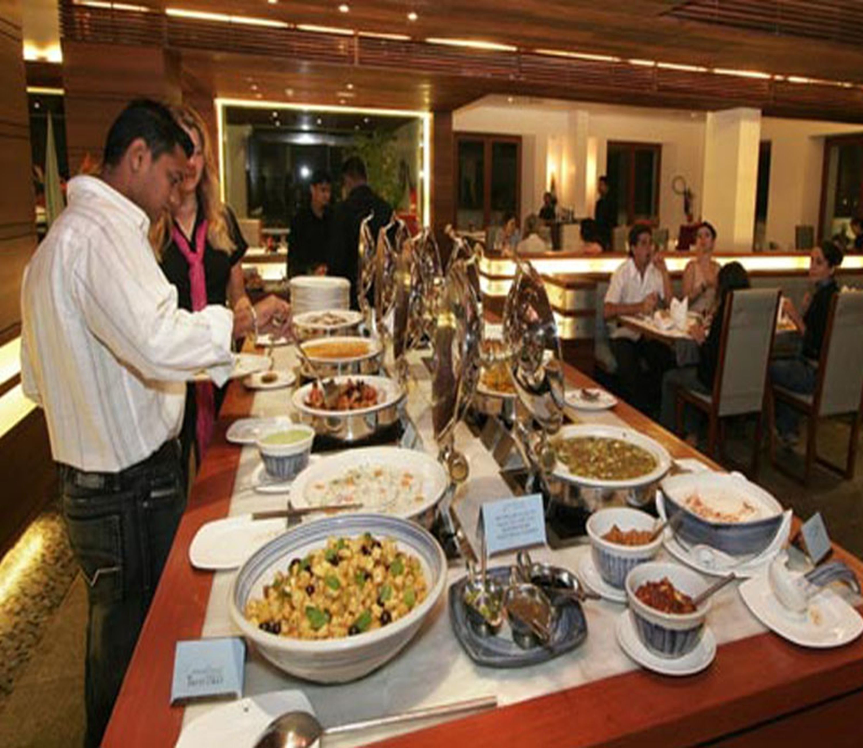 Ein reichhaltiges Buffet mit verschiedenen Speisen und einer Anrichtestation.
