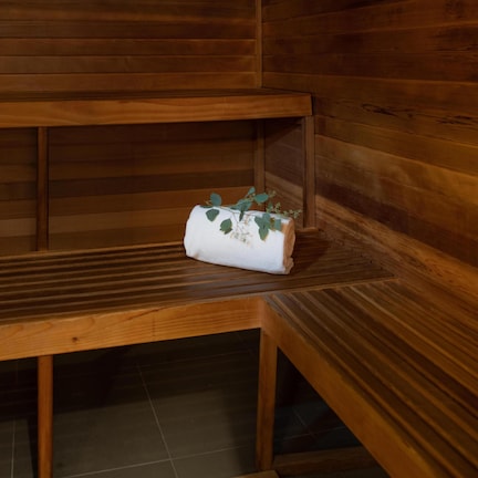 A wooden bench with a towel and a small plant.