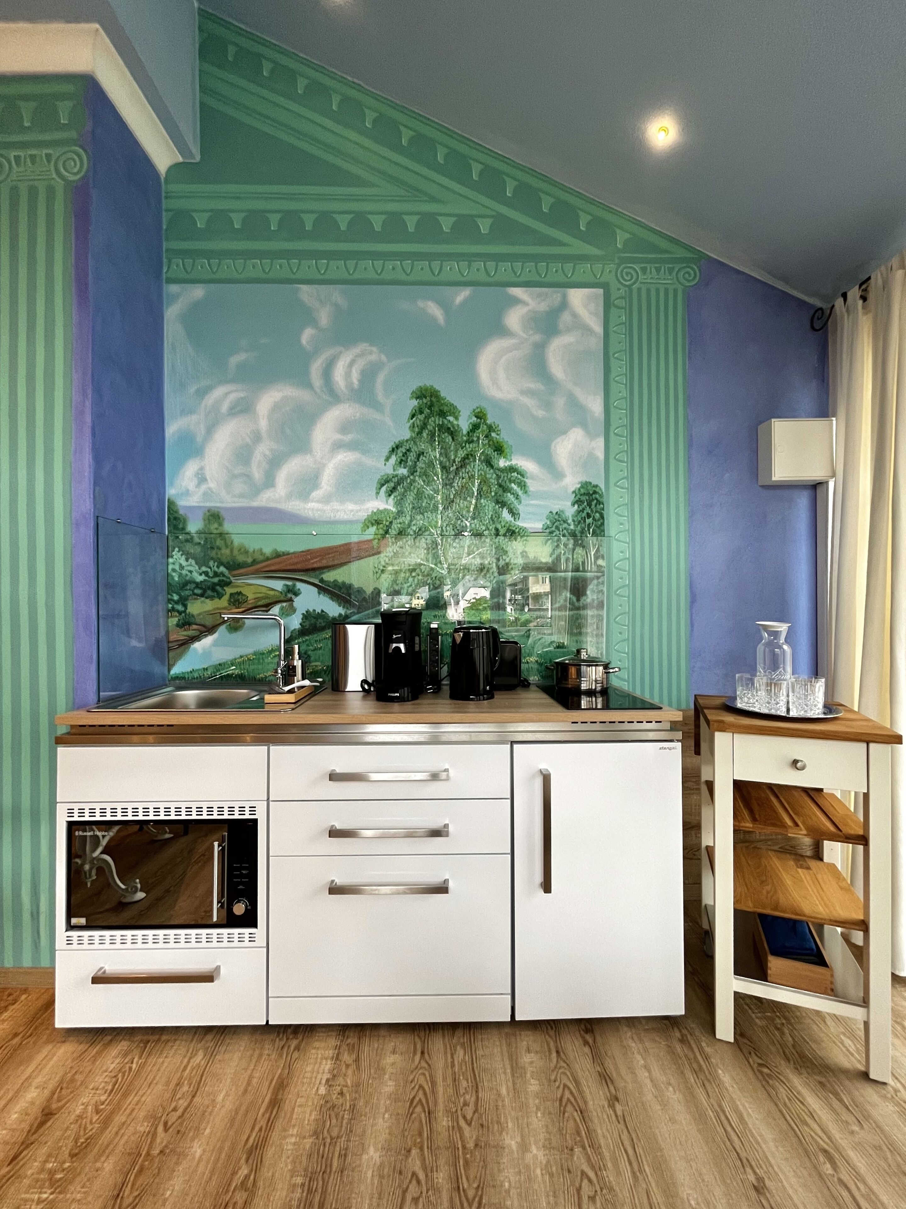 A kitchen with a built-in dishwasher, a coffee maker, and a sink.