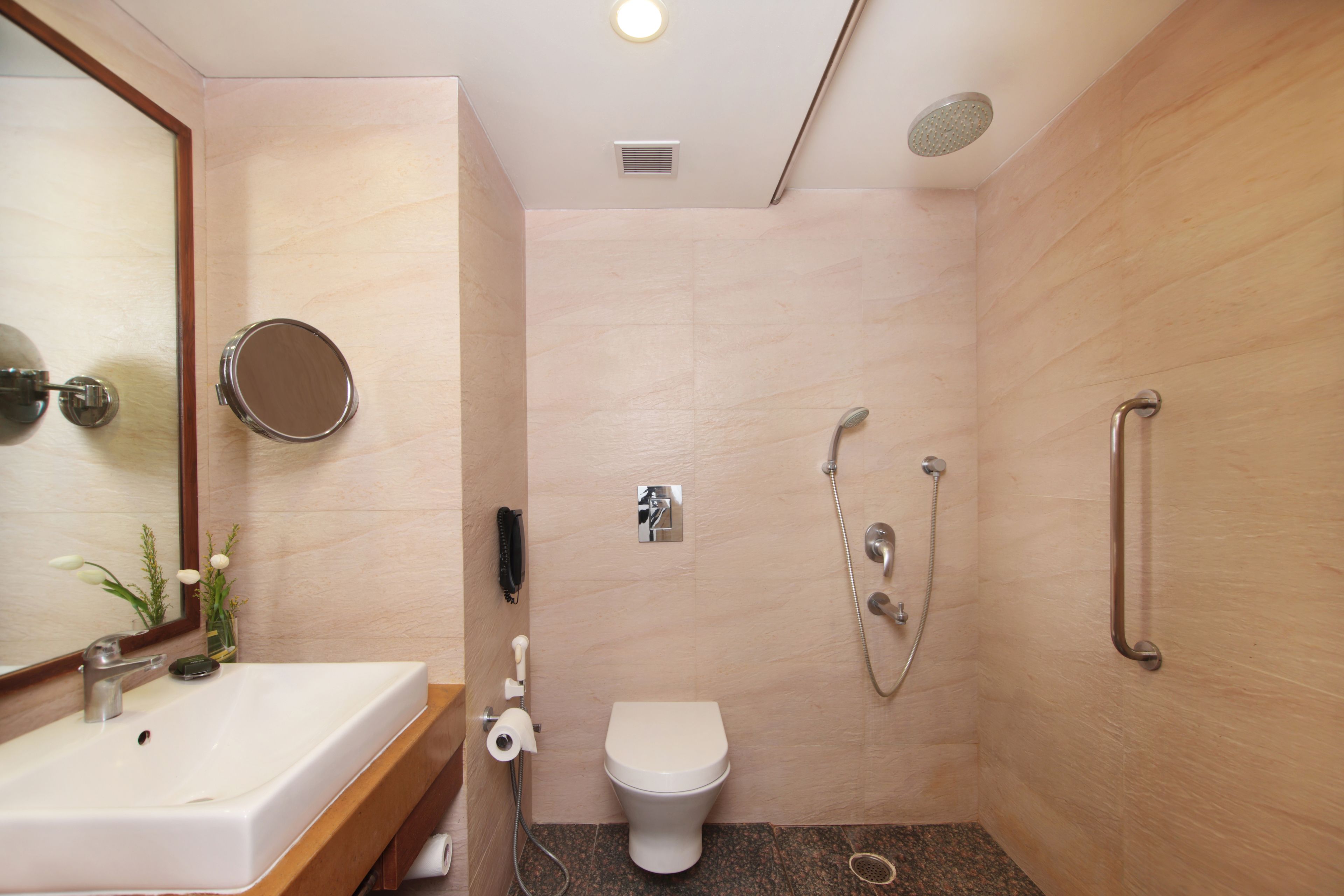 A modern bathroom with a sink, toilet, and shower.