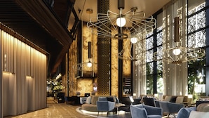 Un lobby moderno con piso estampado, zona de estar e iluminación decorativa.