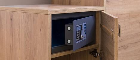 A wooden cabinet with a built-in safe.