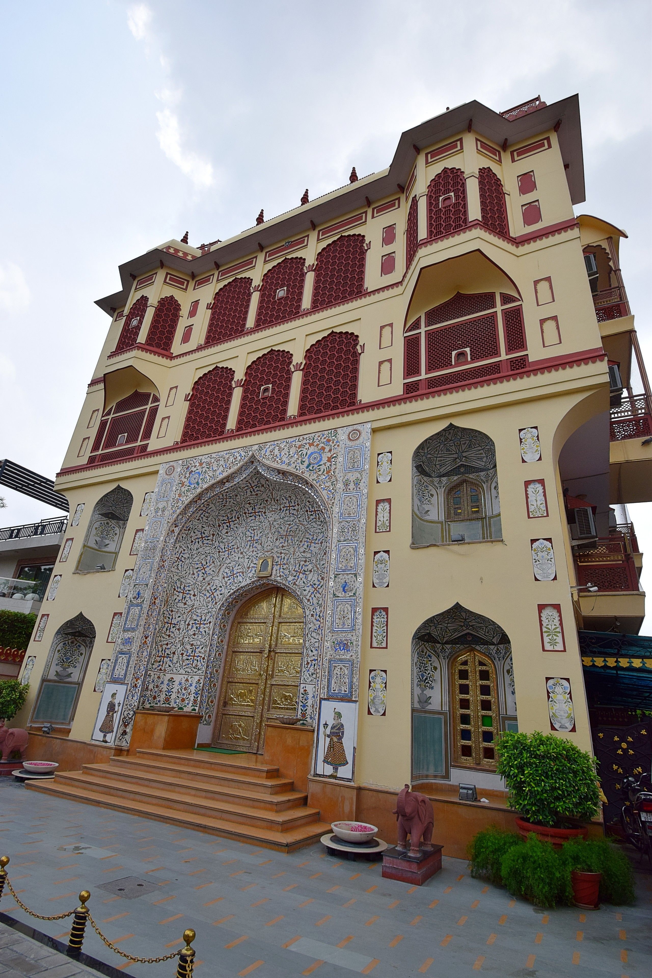A multi-story building with ornate architectural details, including a large arched entrance and decorative windows.