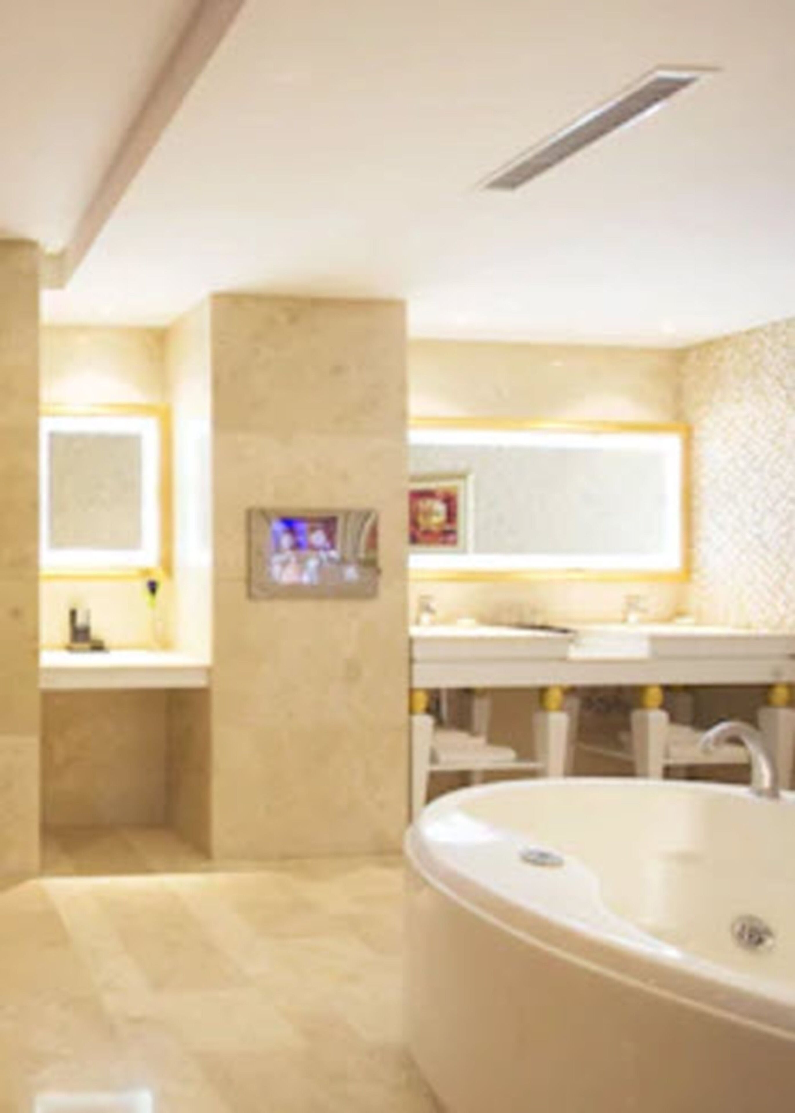 A modern bathroom with a freestanding bathtub, a large mirror, and a vanity with a sink.