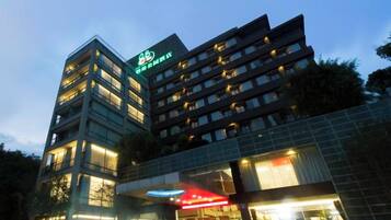 A multi-story hotel building with illuminated signage and a prominent entrance.