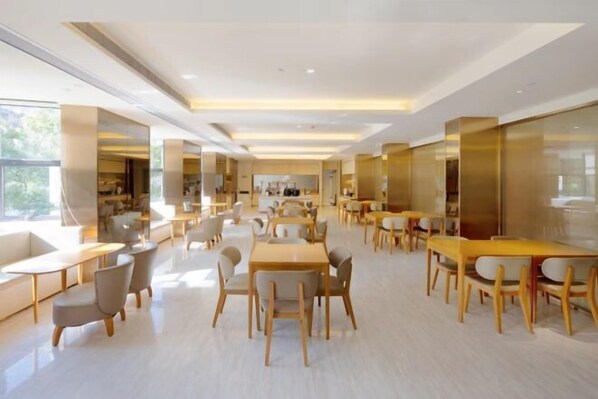 A spacious, modern dining area with multiple tables and chairs, large windows, and a clean, minimalist design. - JI Hotel (Baizhang East Road Ningbo) (Ningbo)
