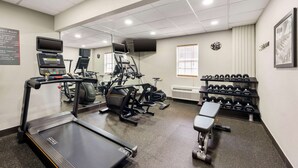 A gym with treadmills, elliptical machines, and dumbbells. - Best Western Gen X Inn (Memphis)