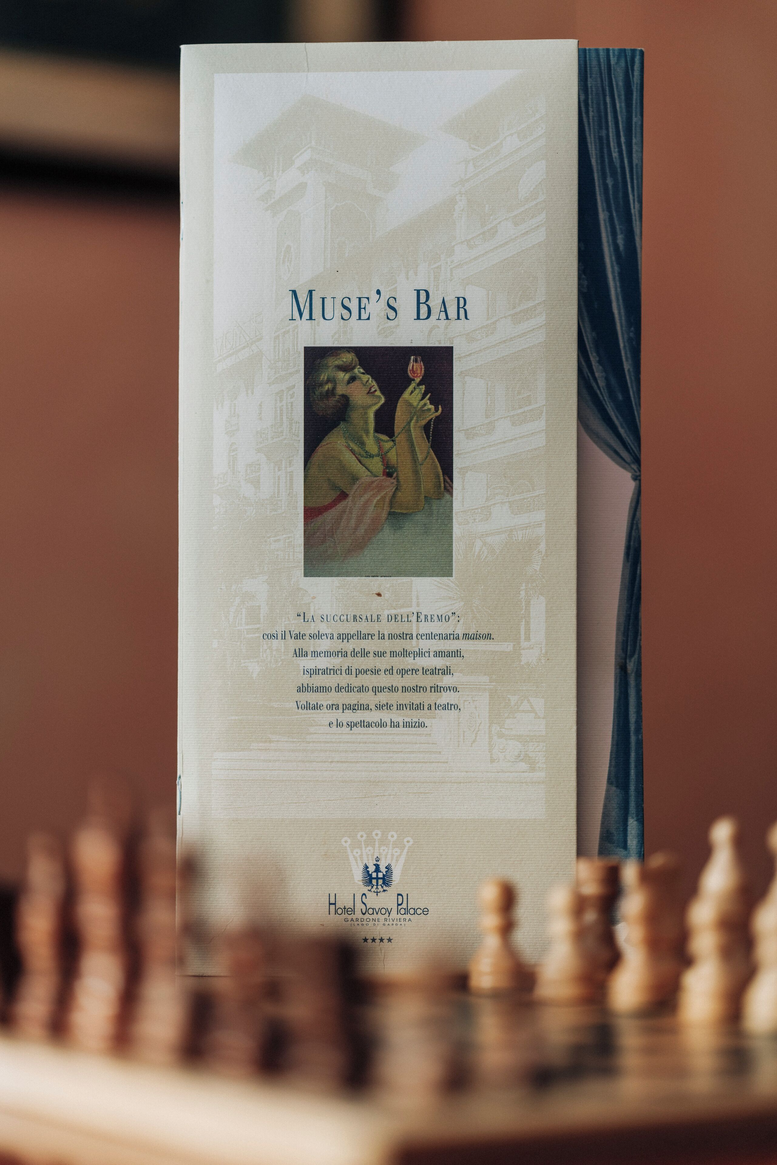 A brochure titled "MUSE'S BAR" with a classical building illustration and a quote in Italian.