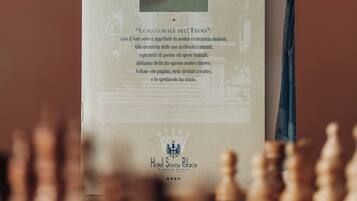 A brochure titled "MUSE'S BAR" with a classical building illustration and a quote in Italian.