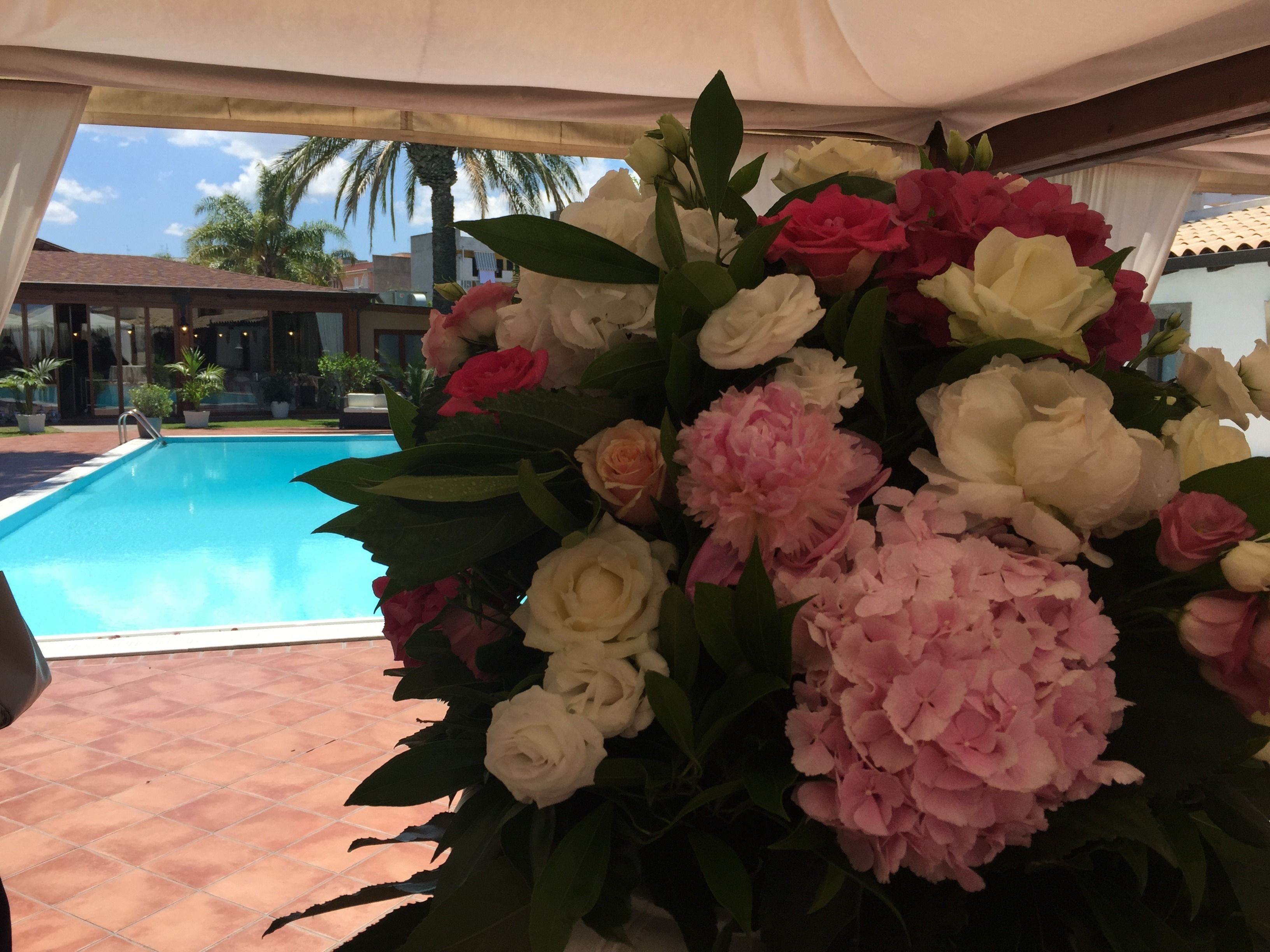 Ein Poolbereich mit einer großen Blumenkomposition.