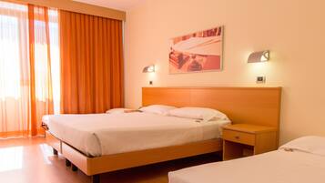 Ein Hotelzimmer mit einem großen Bett, einem Nachttisch und einer Wandleuchte.