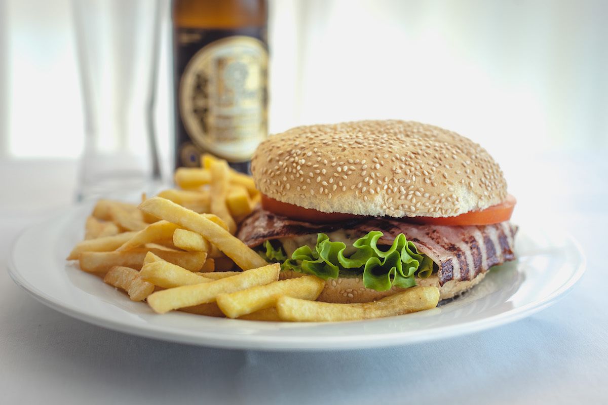 A plate with a hamburger and French fries.