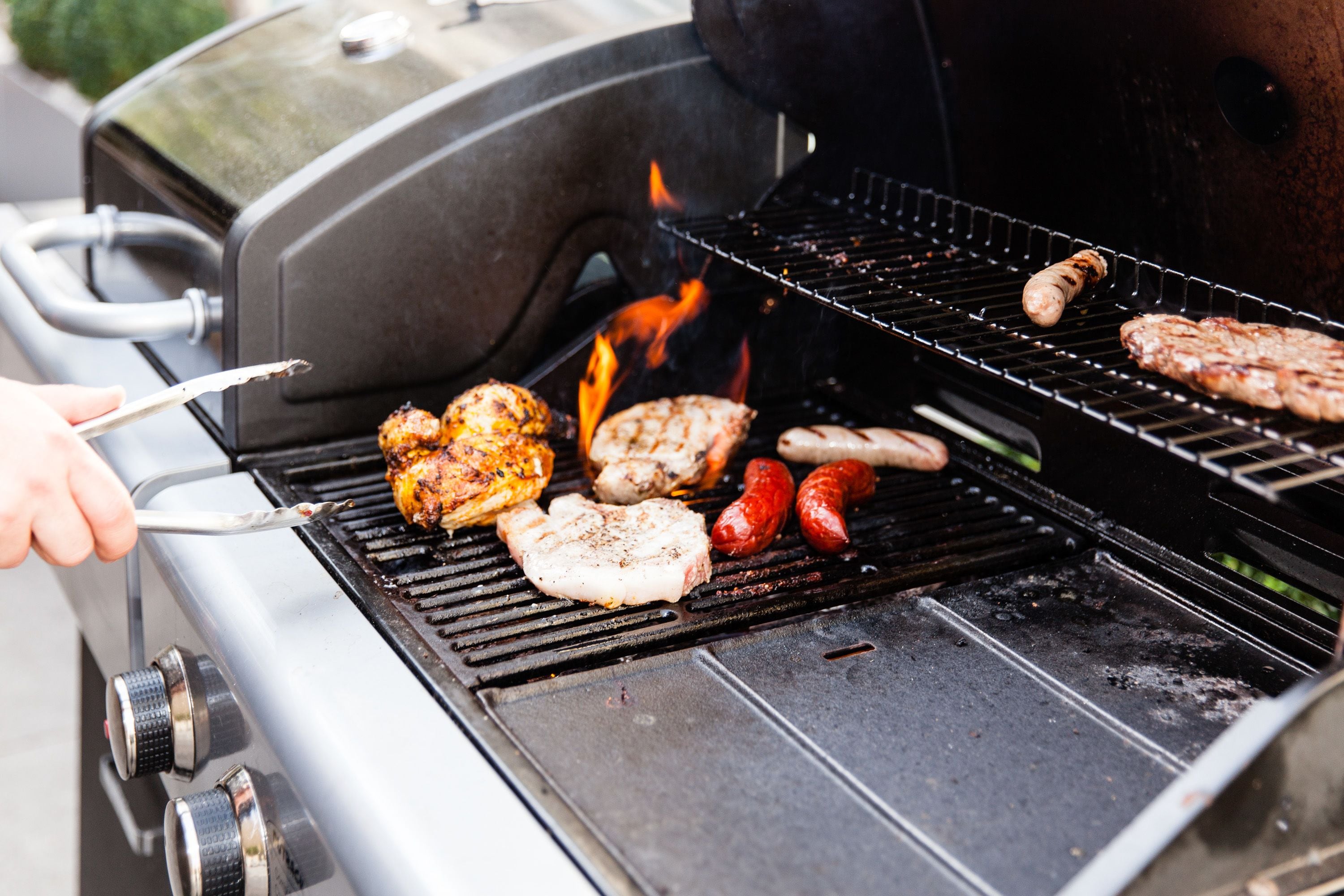 A grill with various meats being cooked.