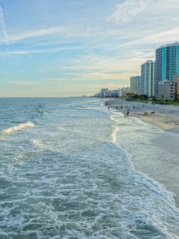 On the beach, surfing