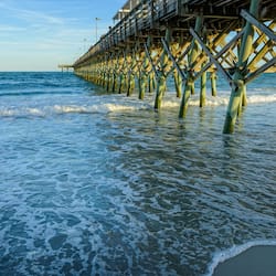 On the beach, surfing