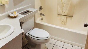 A bathroom with a toilet, sink, and bathtub.