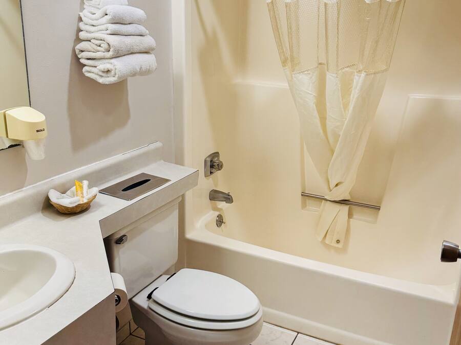 A bathroom with a toilet, sink, and bathtub.
