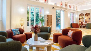 A spacious lobby with comfortable seating, large windows, and a well-lit interior.