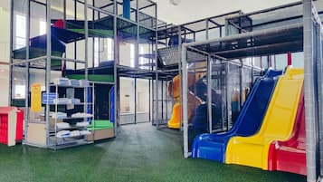 Kids can play safely on the enclosed play structures with slides and climbing elements.