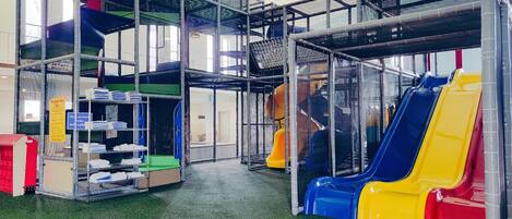 A play area with slides and a climbing structure.