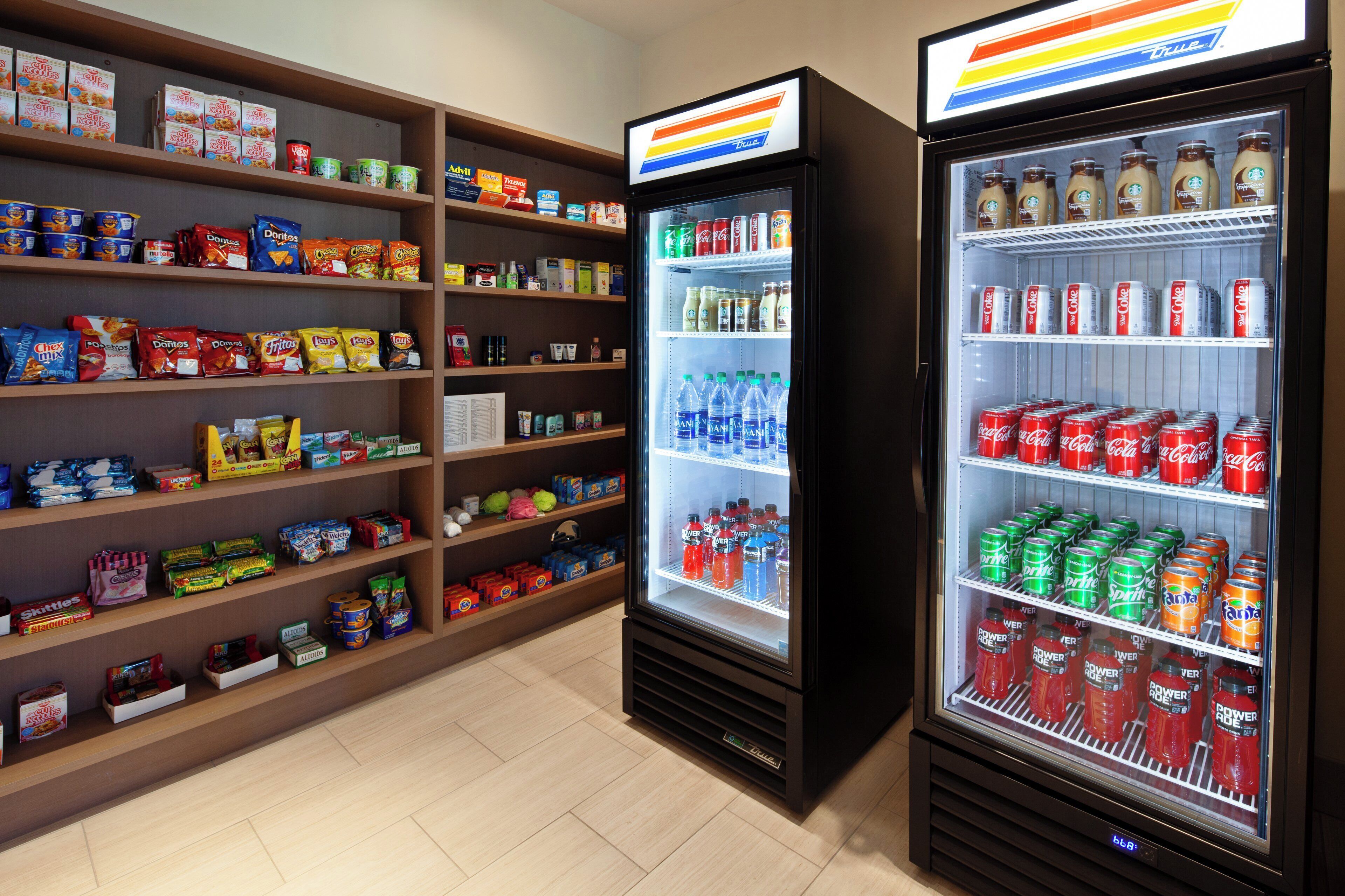A snack and beverage vending area with various snacks and drinks.