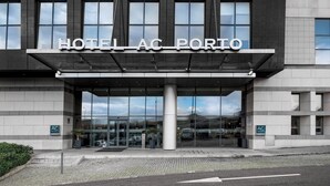 A modern hotel entrance with a clear sign reading "HOTEL AC PORTO". - AC Hotel Porto by Marriott (Porto)