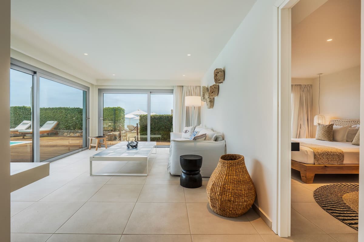 A spacious living area with a large sliding glass door leading to an outdoor seating area.