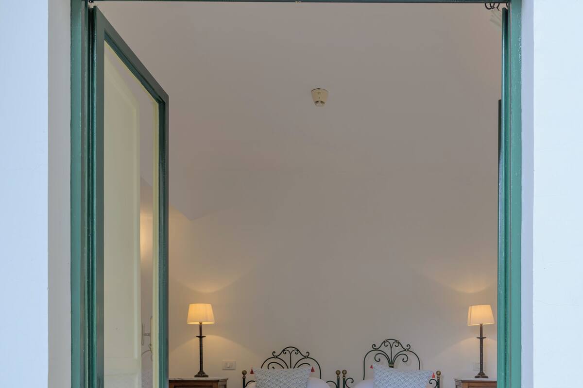 A bedroom with a bed, two bedside tables, and a nightstand.