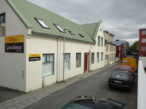 A building with a sign indicating it is a guesthouse.