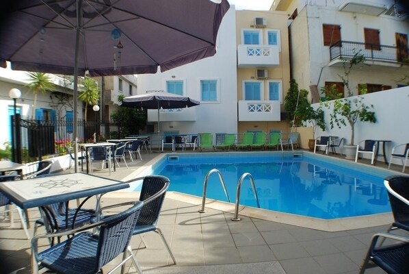 Seasonal outdoor pool, pool umbrellas, pool loungers