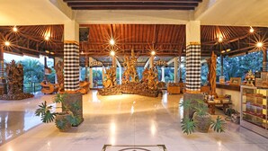 A spacious lobby with a checkered floor pattern, a central statue, and potted plants. - Bhanuswari Resort & Spa (Ubud)