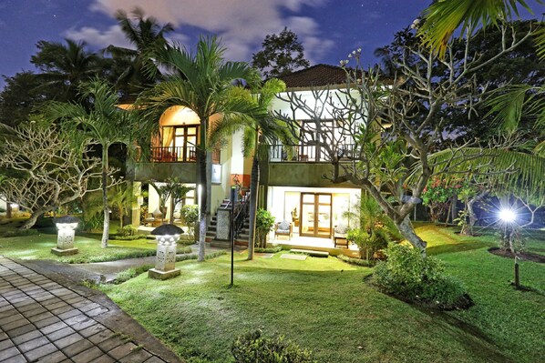 Vista frontal de la propiedad por la tarde o noche