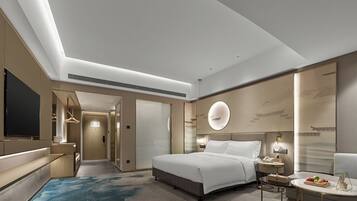 A modern hotel room with a large bed, bedside tables, a TV, and a bathroom visible through an open door.