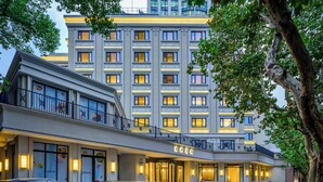 A hotel with a modern facade, multiple floors, and a prominent entrance with a sign. - Donghu Collection Hotel Shanghai (Shanghai)