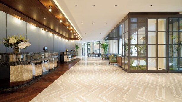 A modern lobby with a reception desk, seating area, and large windows. - Donghu Collection Hotel Shanghai (Shanghai)