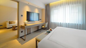 A modern hotel room with a large bed, a desk with a flat-screen TV, a sofa, and a large window with curtains. - Donghu Collection Hotel Shanghai (Shanghai)