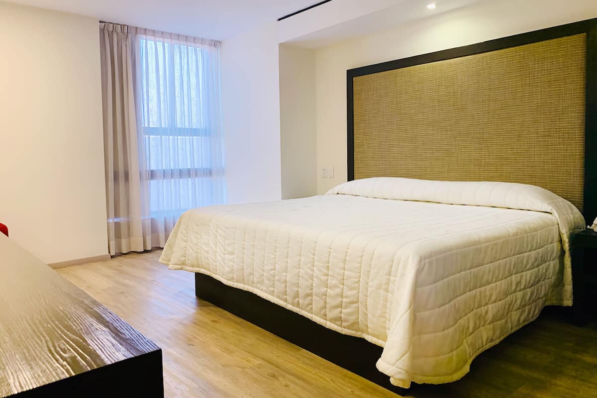 Deluxe Suite, Courtyard View | In-room safe, desk, laptop workspace, blackout drapes