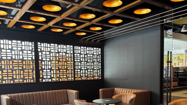 A modern interior with leather seating, round tables, and pendant lighting. - Hotel Lepanto Reforma (Mexico City)