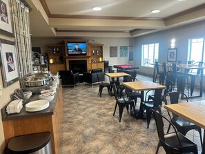 A restaurant with a pool table, dining tables, and chairs.