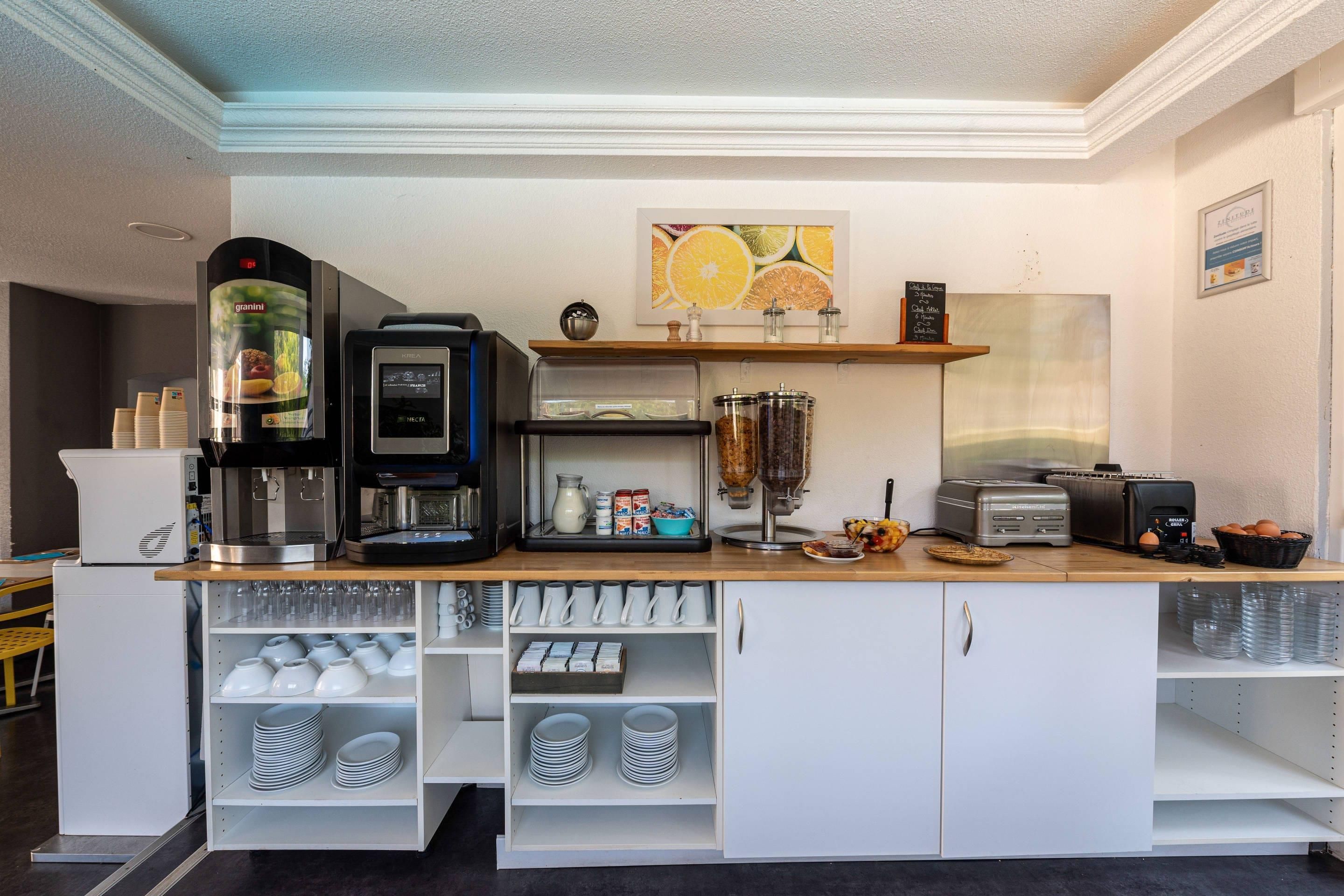 Een ontbijtbuffet met een koffieapparaat, broodrooster en diverse etenswaren.