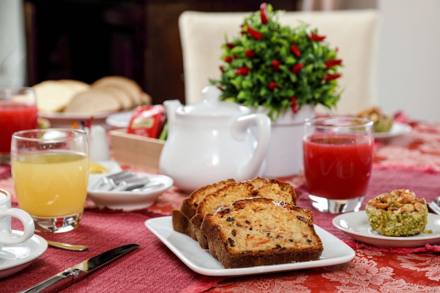 A breakfast table with toast, fruit, and beverages.